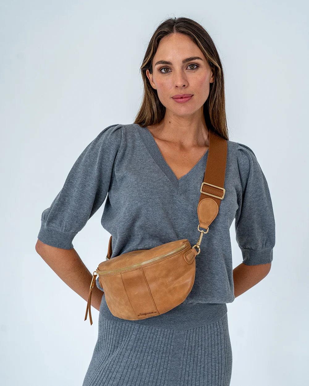 Woman using Arlington Milne Zara Sling Bag - Vintage Tan