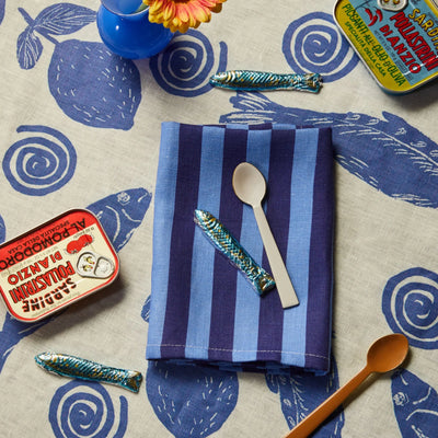 top view of table bonnie and beil linen table cloth with blue sardines design print.