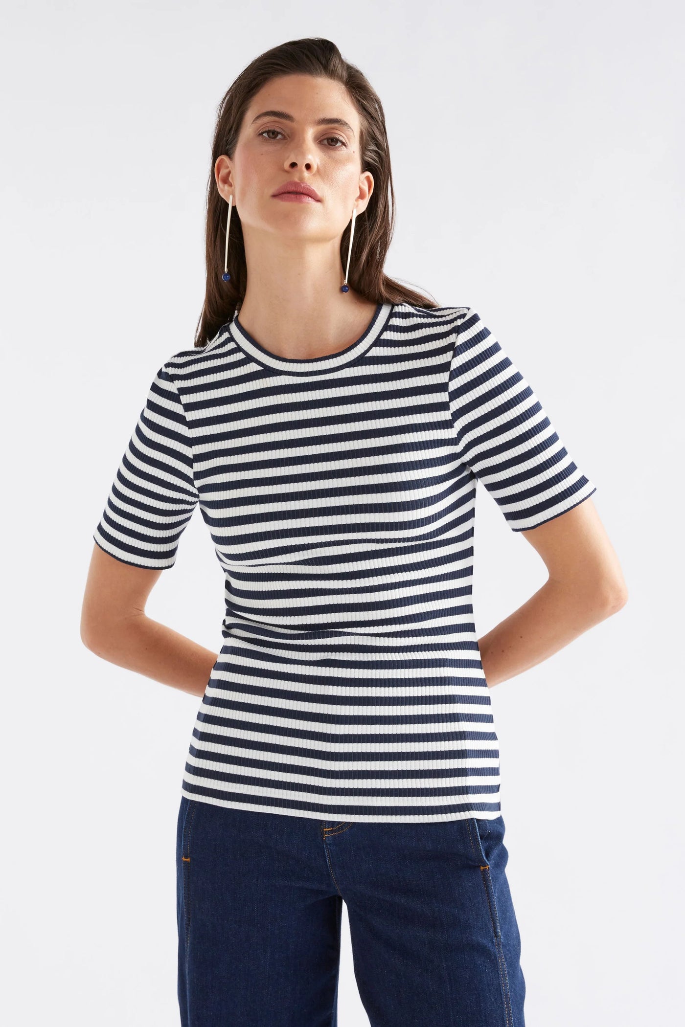 woman wearing kullan ribbed shirt white ink stripe and dark blue denim pants