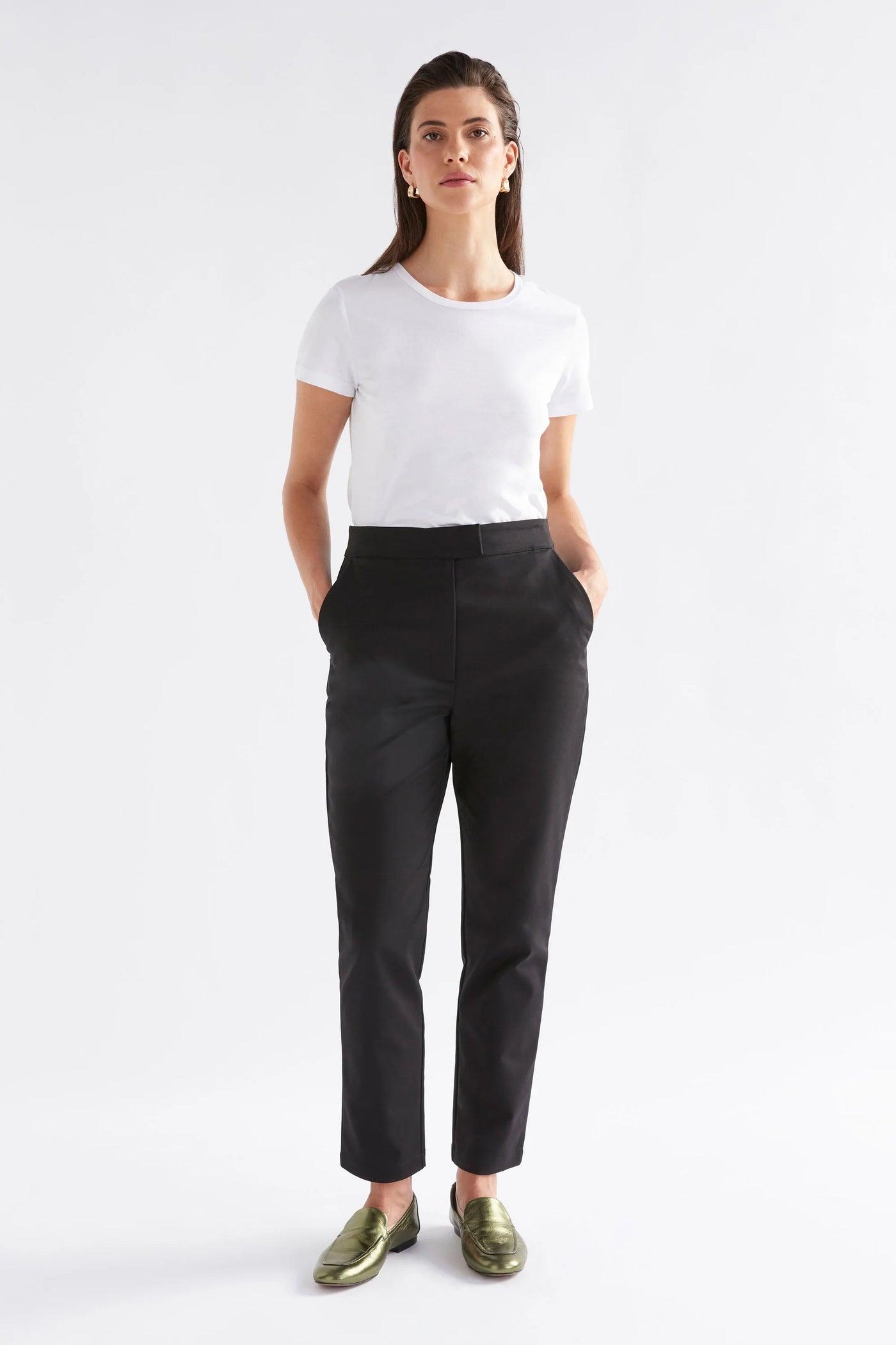 Woman wearing white shirt and black pants