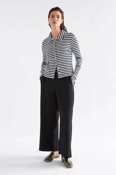 Woman wearing long sleeve stripe top and black pants