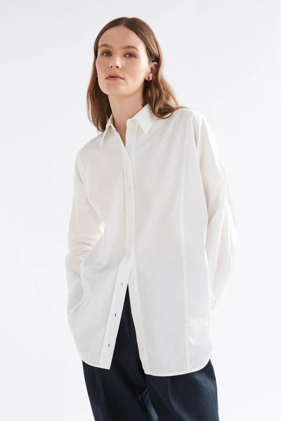 Woman facing wearing tiga shirt in white