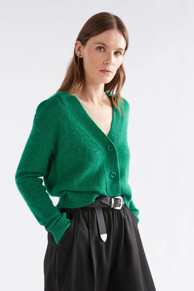 Woman wearing Daaru Cardigan in Milan Green and black bottoms