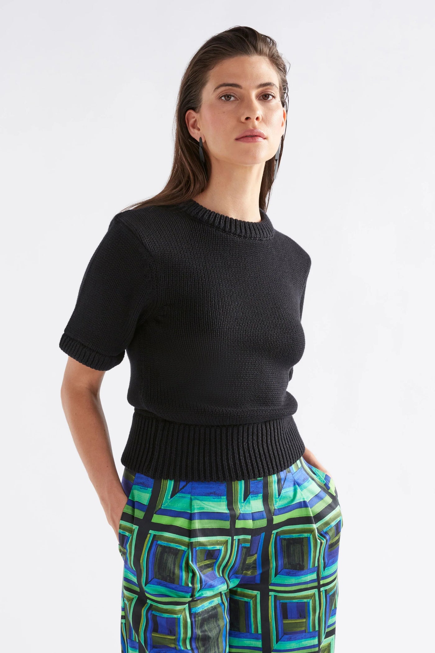 Woman wearing Black Lift Knit Top and blue-green square print pants