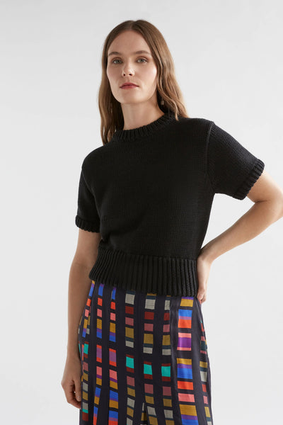 Woman wearing Black Lift Knit Top and Multi-coloured skirt