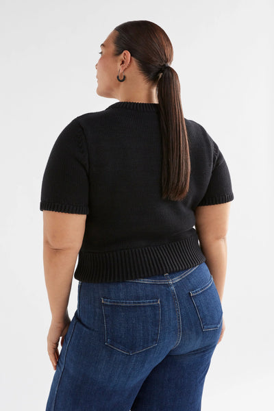 Plus Size Woman wearing Black Lift Knit Top and denim pants