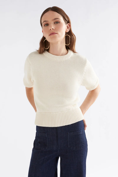 Woman wearing Luft Knit Top in White and Dark Blue Denim pants