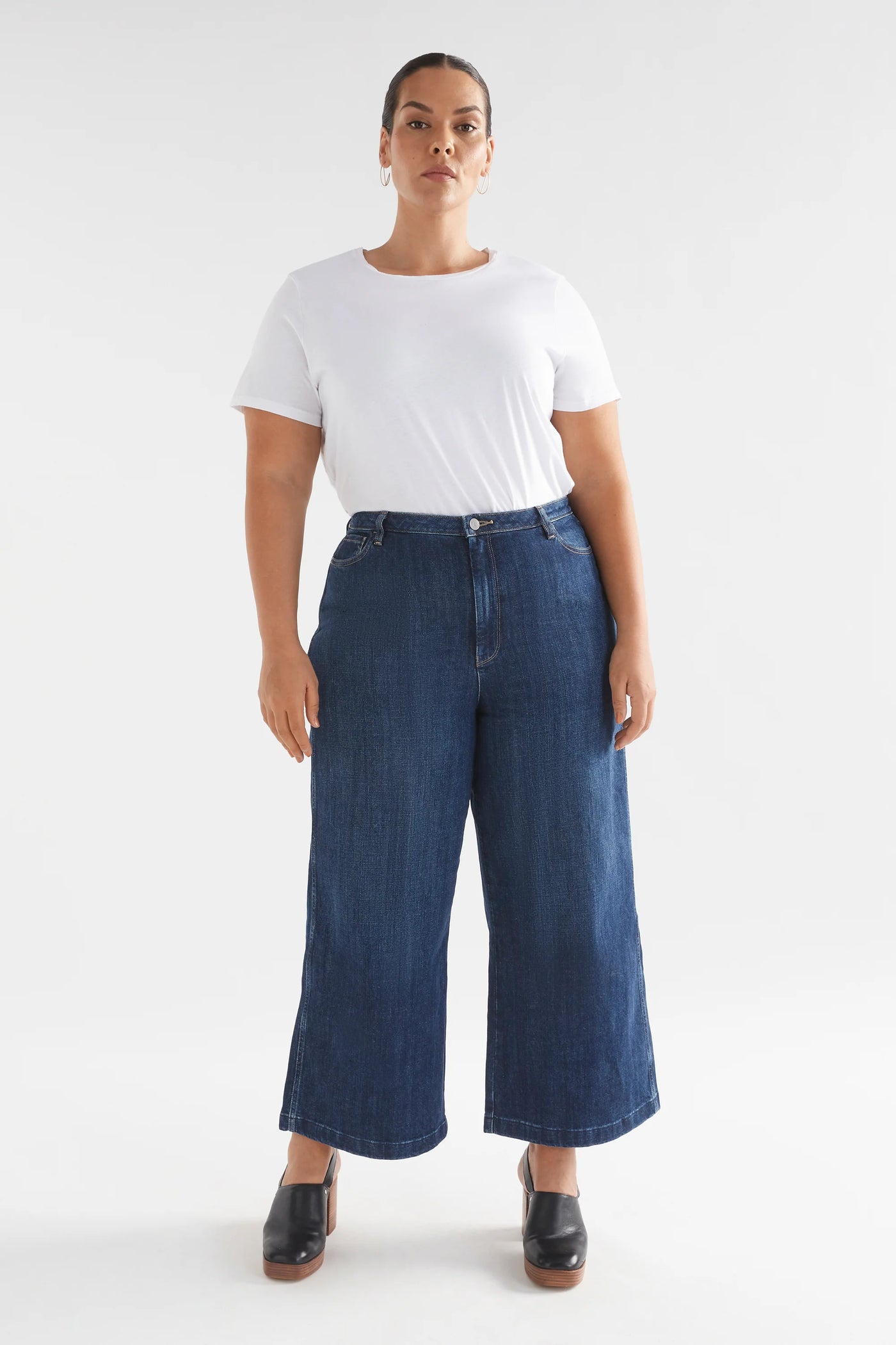 Plus size Woman wearing White top and Tovi Regen Jean Dark Blue