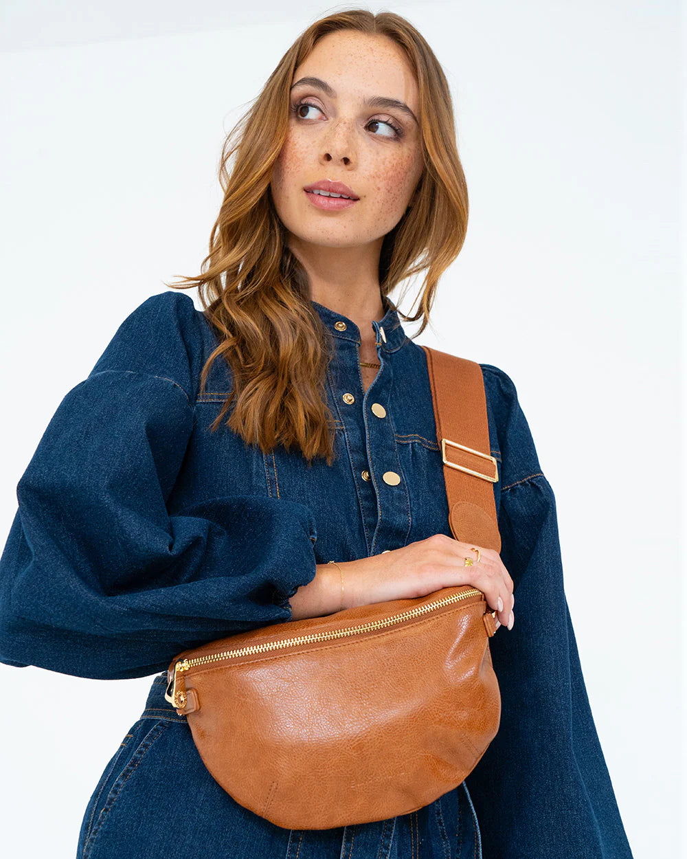 Woman in denim using Alamo Sling - Tan Pebble