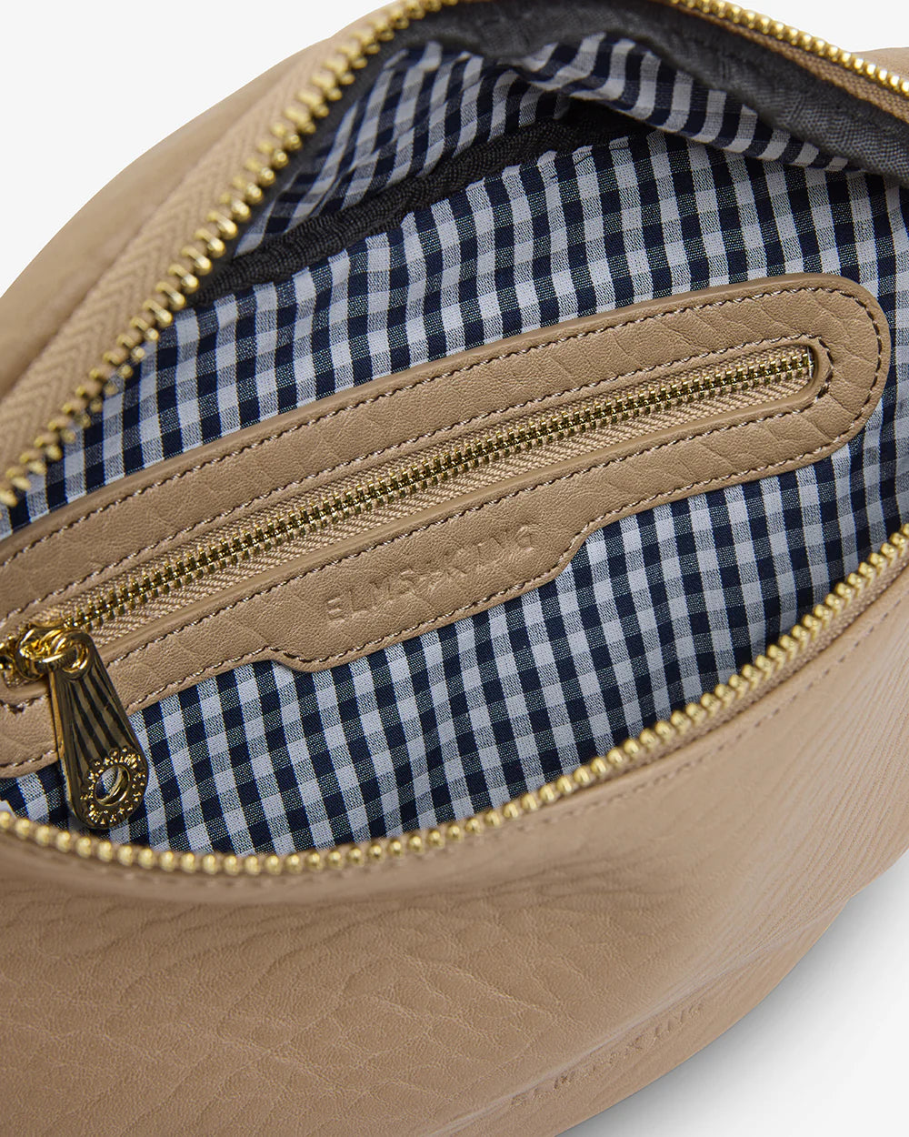 Inside details of Alamo Sling - Latte, checkered inner and gold zipper