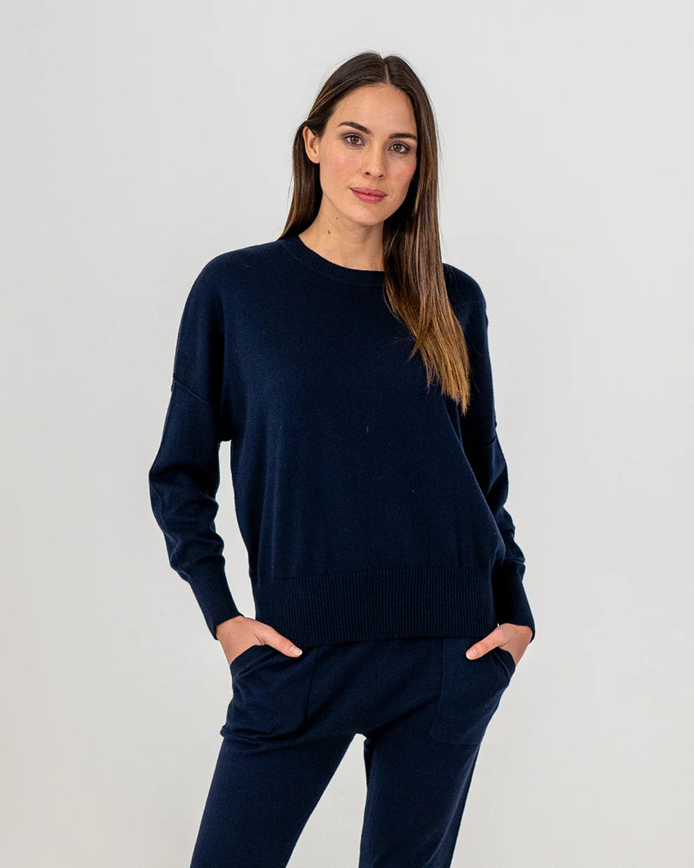 Woman wearing Lucy Knit in Navy and Track pants in navy