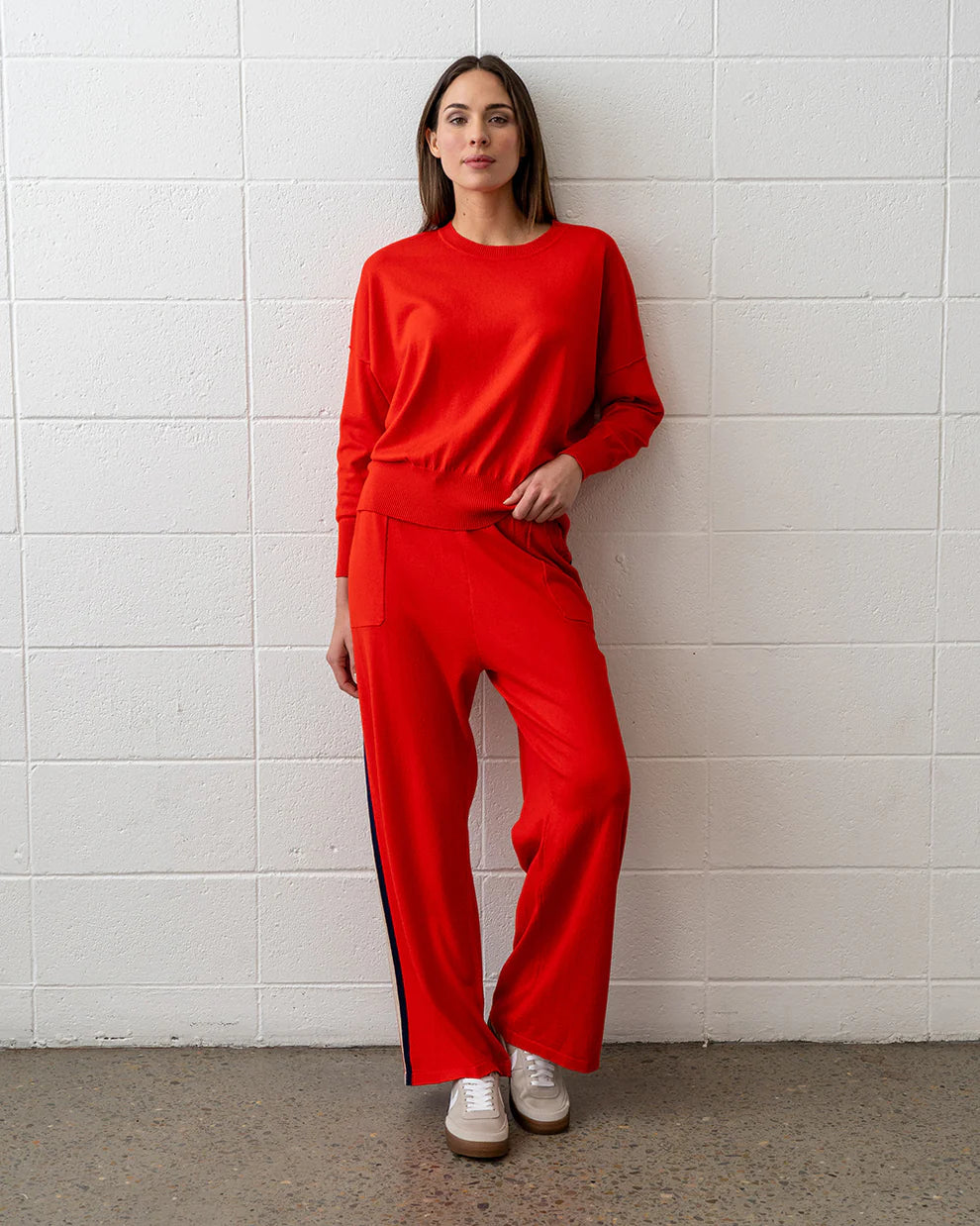 Woman wearing Lucy Knit in Poppy and pants in Poppy colour