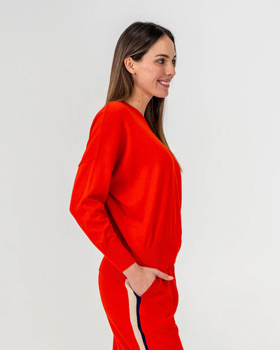 Woman wearing Lucy Knit in Poppy and  pants in Poppy colour side view