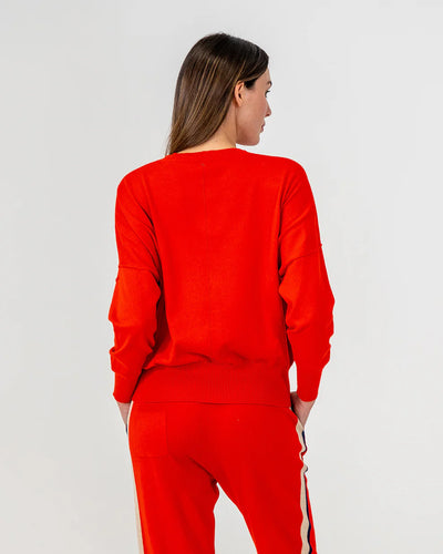 Woman wearing Lucy Knit in Poppy and pants in Poppy colour back view