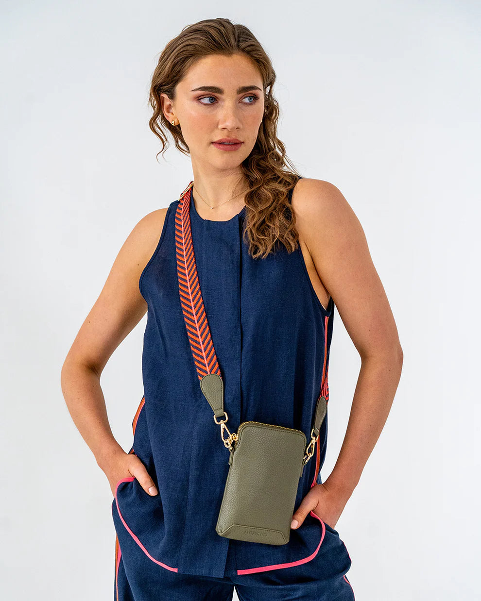 Woman wearing Elm and King Sullivan Phone Bag in Khaki