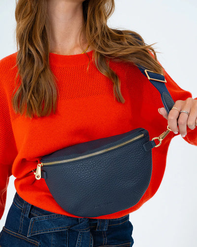 Woman in red top holding Alamo Sling - Navy