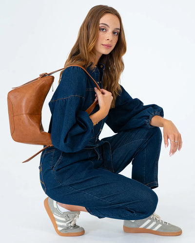 Woman wearing a dBarton Shoulder Bag - Tan Pebblerk blue denim top and pants using Barton Shoulder Bag - Tan Pebble