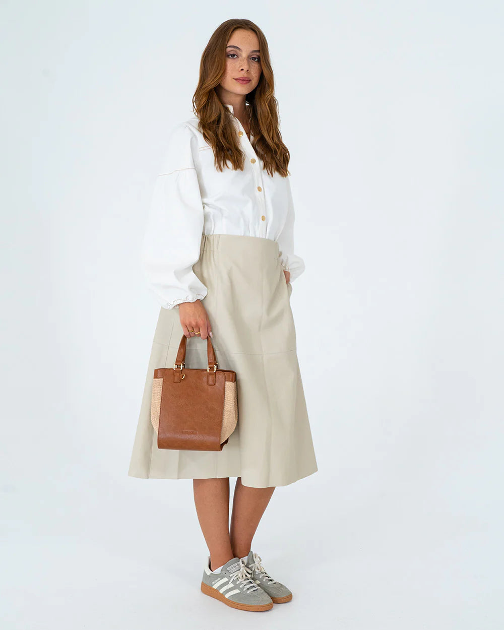 Full body image of woman holding Carnegie Tote - Natural/Tan