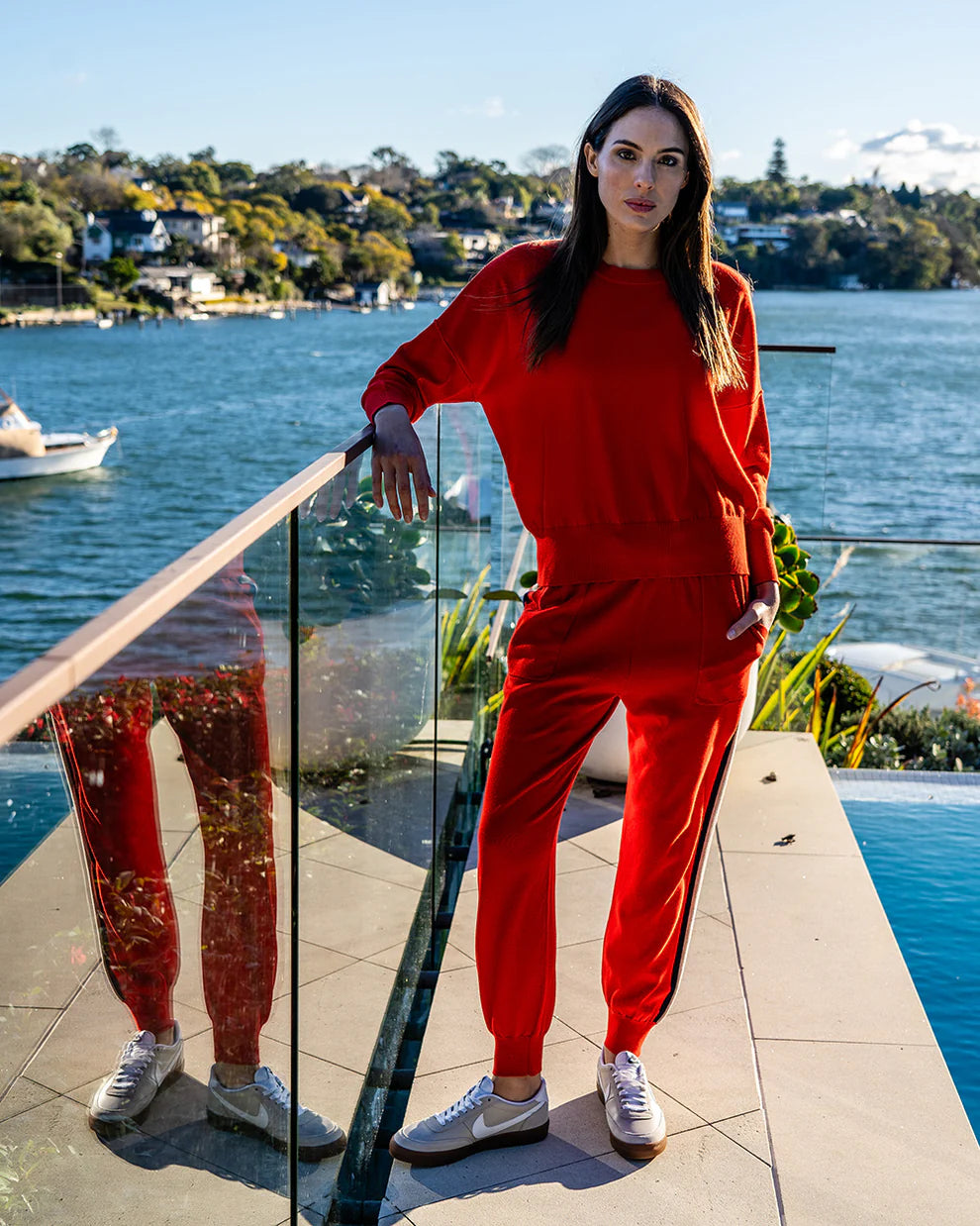 Woman wearing Lucy Knit in Poppy and Track pants in Poppy colour