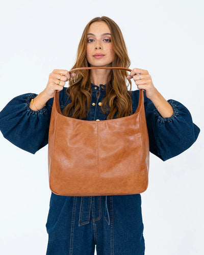 woman holding the Arcadia Tote in Tan Pebble front view