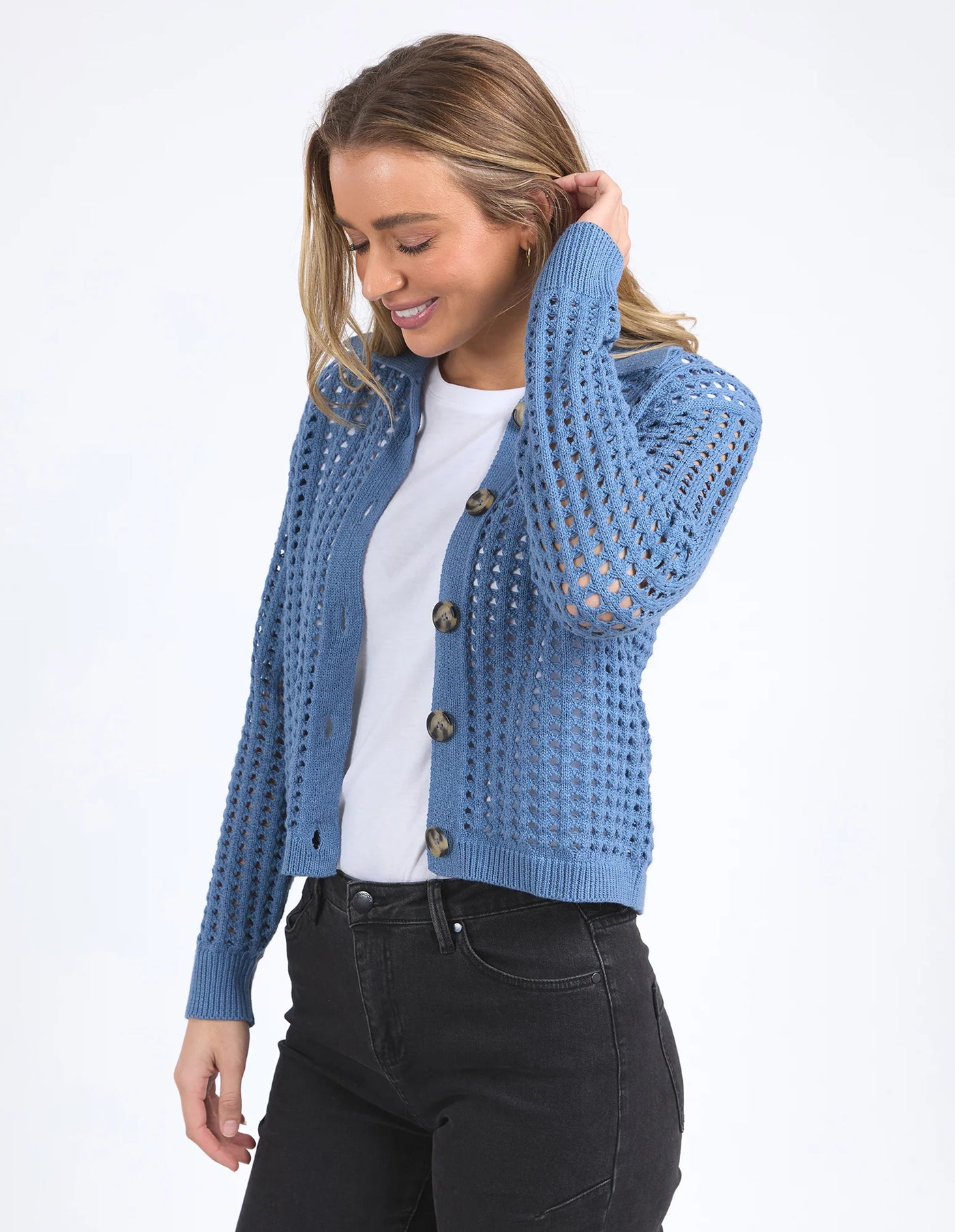 woman wearing Clover Knit Cardi in Coronet Blue, white top and denim skirt