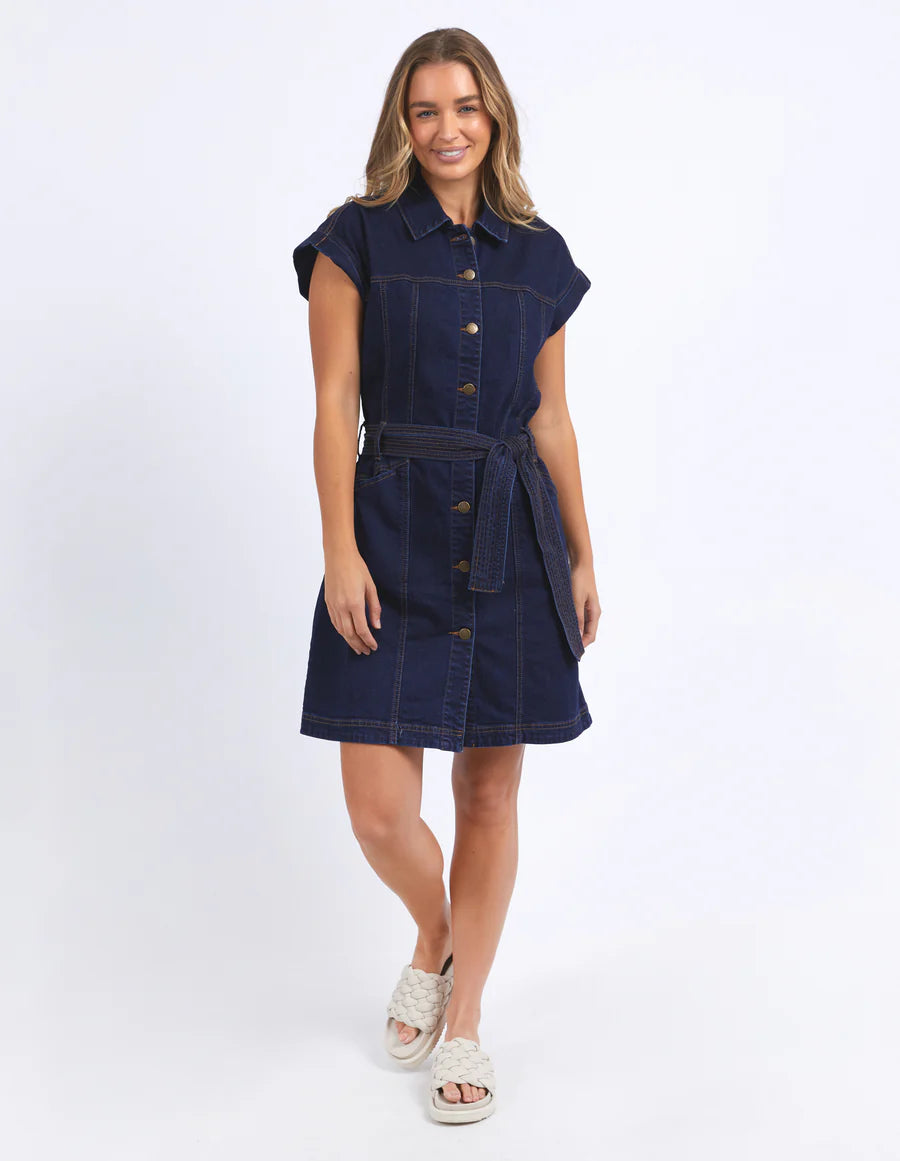 Woman wearing foxwood heidi dress in dark blue denim and slip on