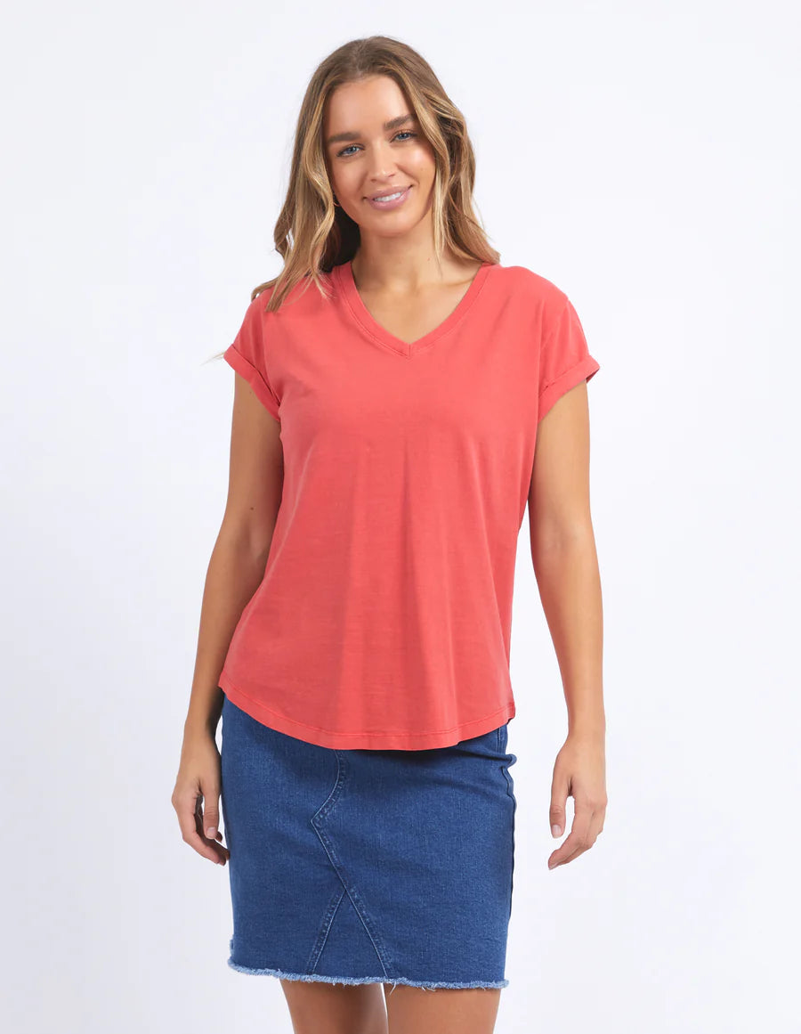 Woman wearing  foxwood manly vee tee in cayenne colour and blue denim skirt