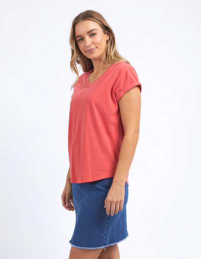 Woman wearing  foxwood manly vee tee in cayenne colour and blue denim skirt