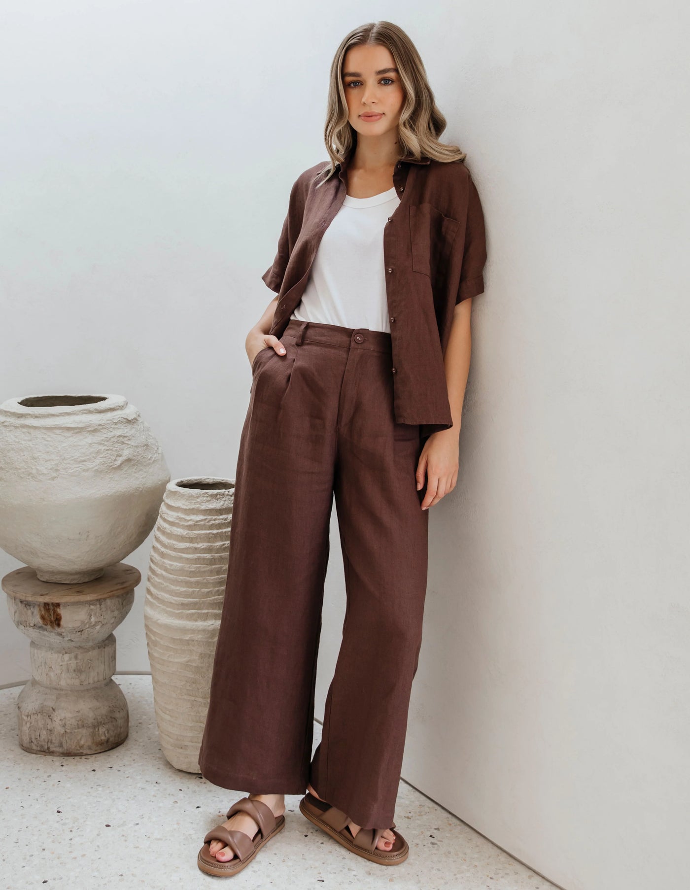 Woman wearing white inner and foxwood pierra shirt and pants in chocolate colour