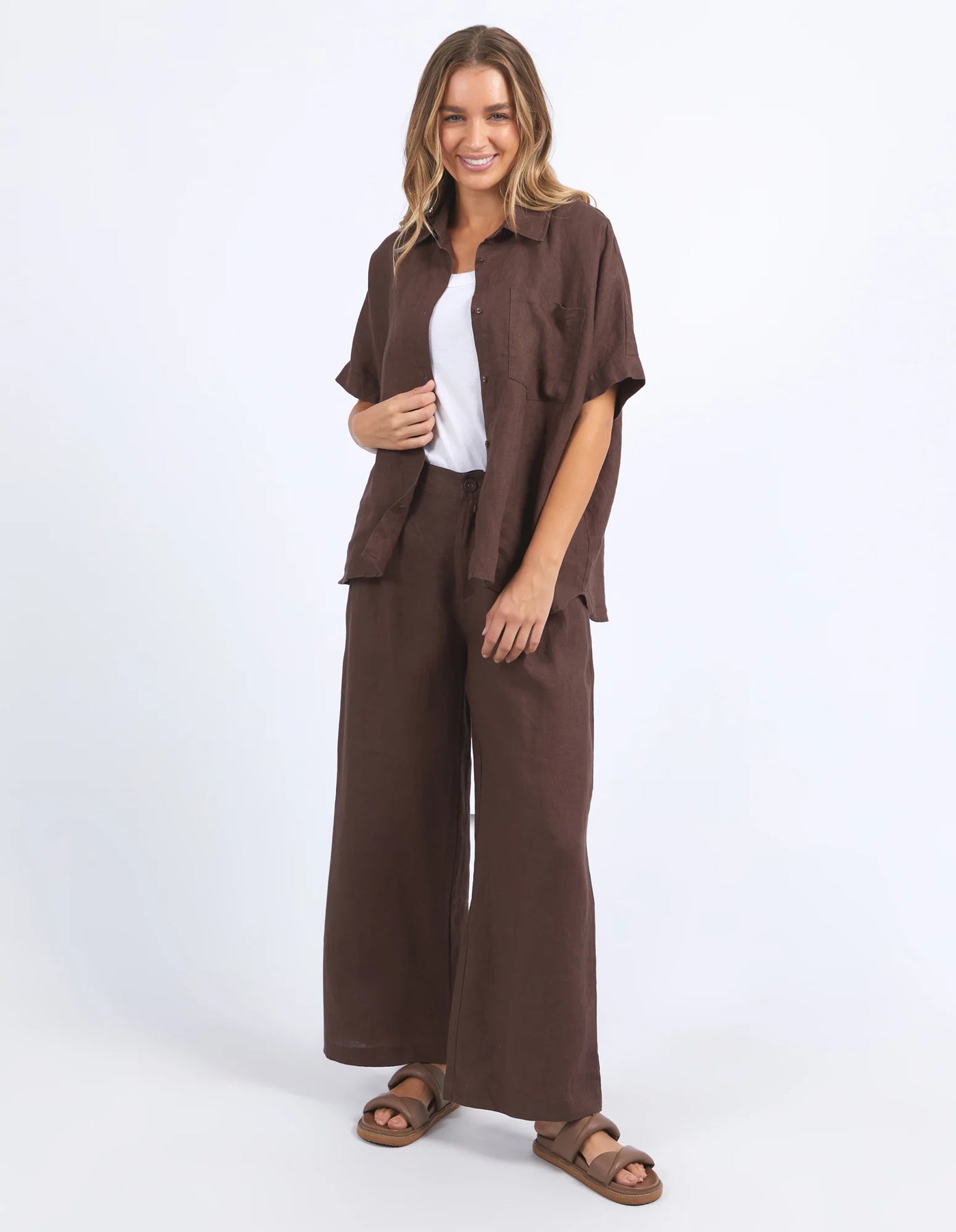 Standing woman wearing white inner and foxwood pierra shirt and pants in chocolate colour