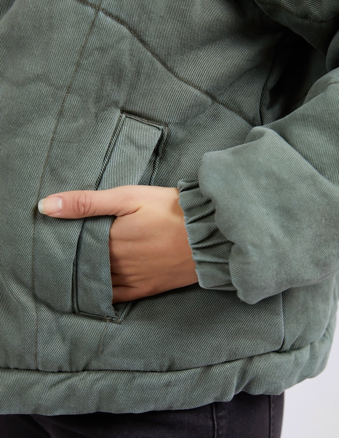 Closer look of woman's hand in the jacket's pocket