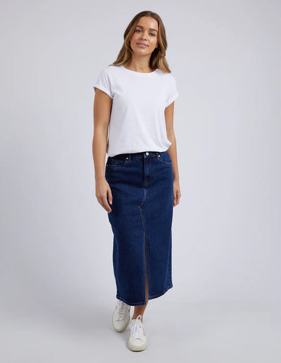 woman wearing white tee, foxwoord scout midi skit in indigo and white shoes