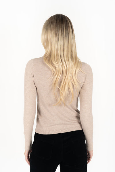 Woman wearing long sleeve Alana Skivvy in Birch and black pants back view