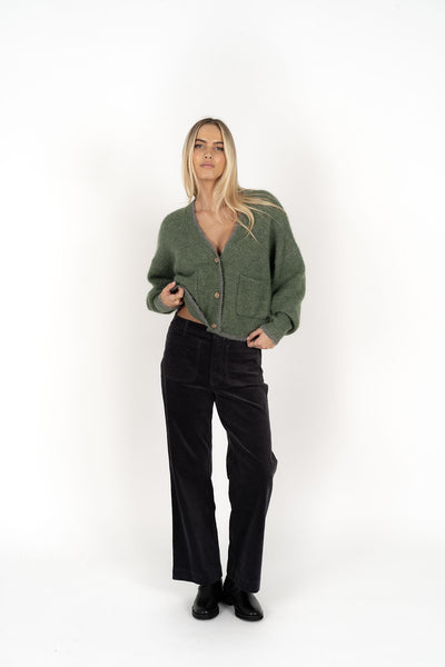 Woman wearing Romi Cardi in Green Grey and black pants