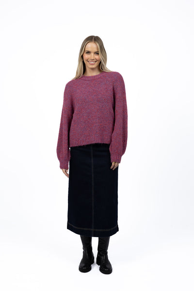 Woman wearing Neve Jumper in Berry and Nevada skirt in black