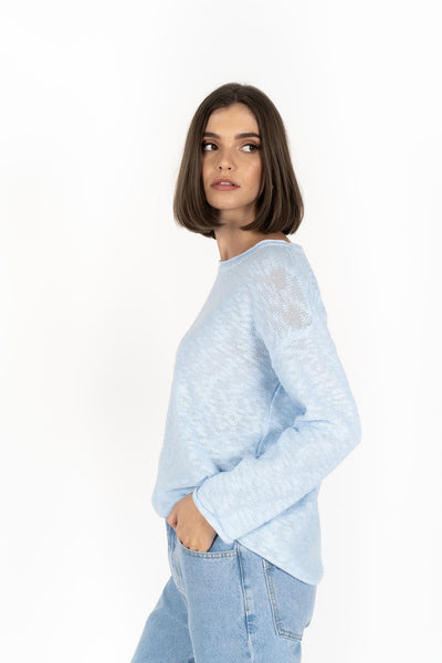 Woman wearing Humidity Lifestyle Sofia Sweater in Powder Blue