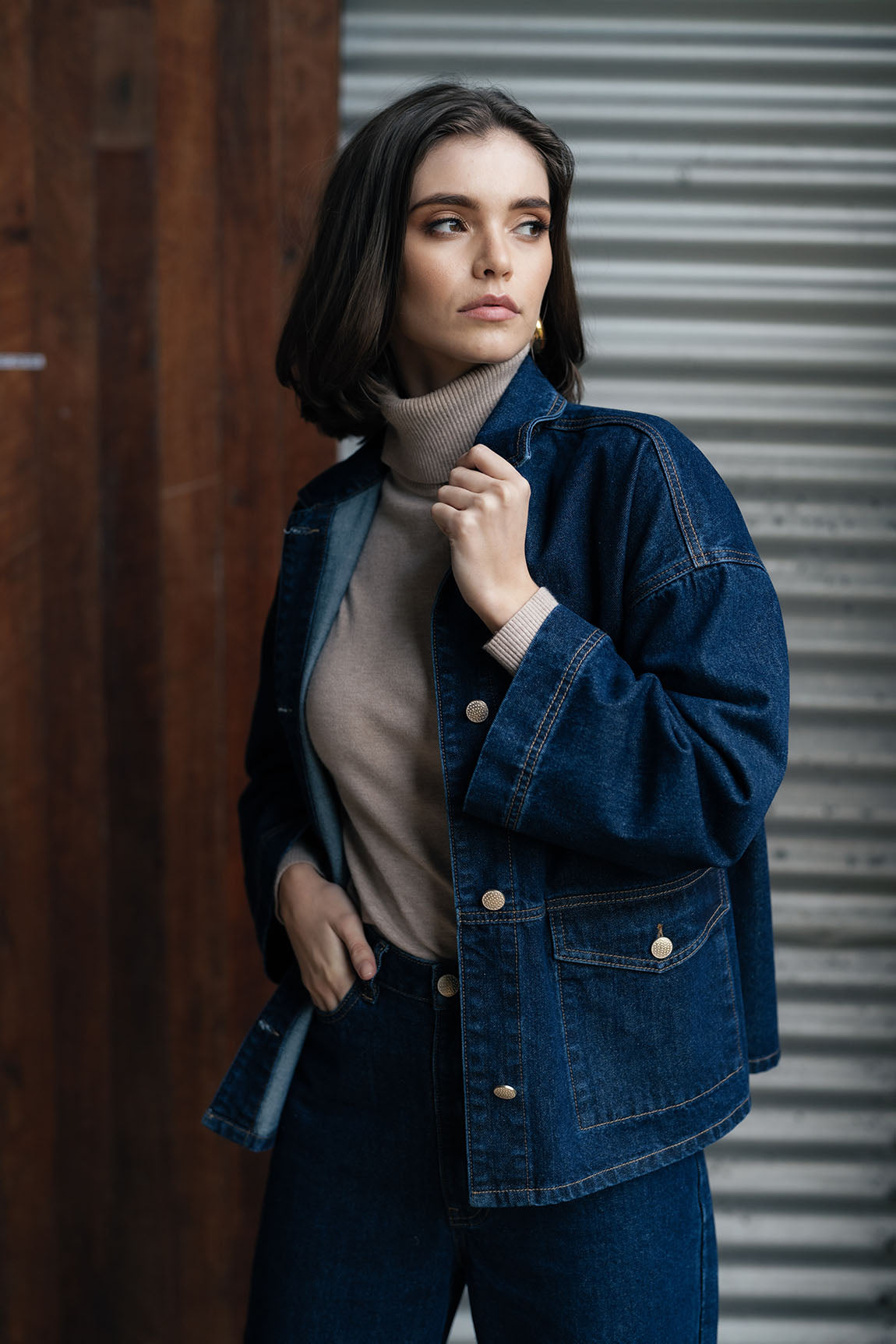 Woman wearing Loz Jacket in dark blue and denim pants