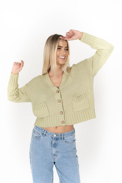 Woman wearing Citta Cardi in Pistachio front view and denim pants