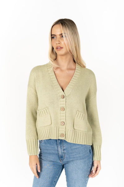 Woman wearing Citta Cardi in Pistachio front view and denim pants