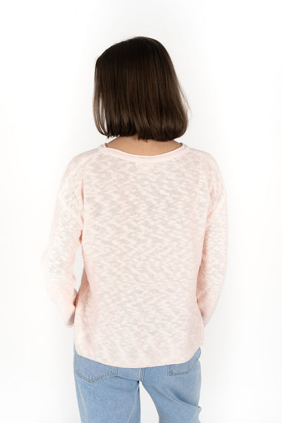 Woman wearing Sofia sweater in peach back view