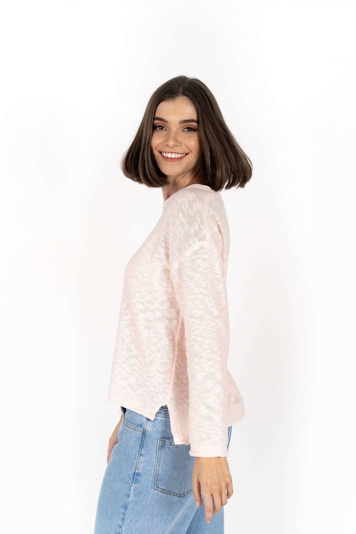 Woman wearing Sofia sweater in peach side view