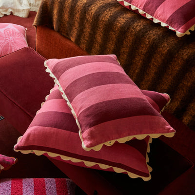 two stack bonnie and neil big stripe cerise 60cm x 40 cm cushion in red sofa