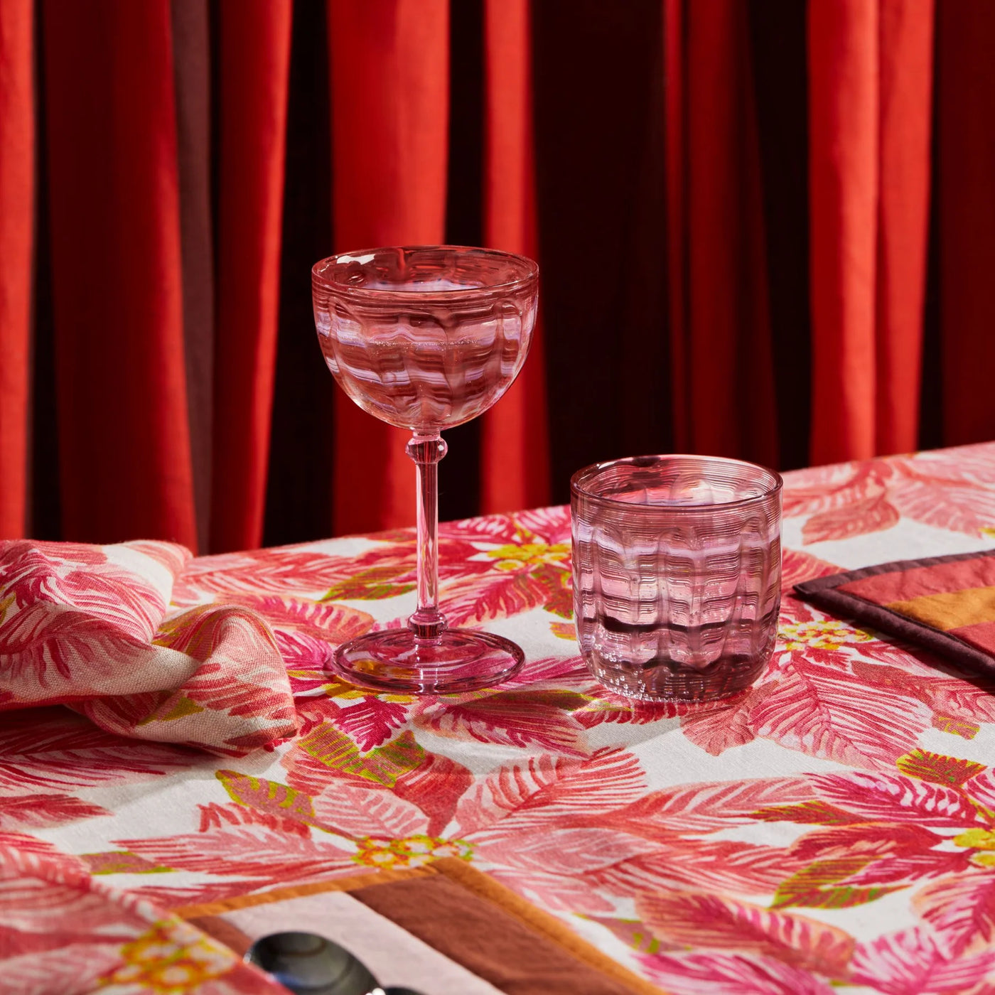 glasses on table with bonnie and neil poinsettia red round tablecloth