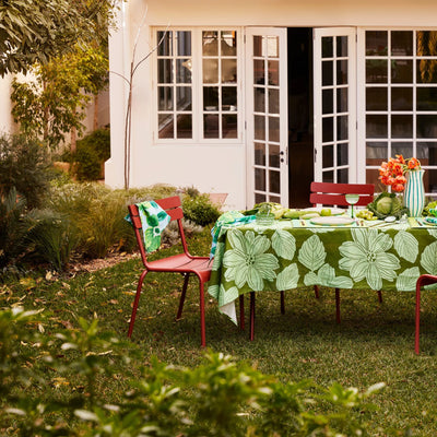 garden with dining set with table decorated with bonnie and neil rosetta blue tablecloth and napkins