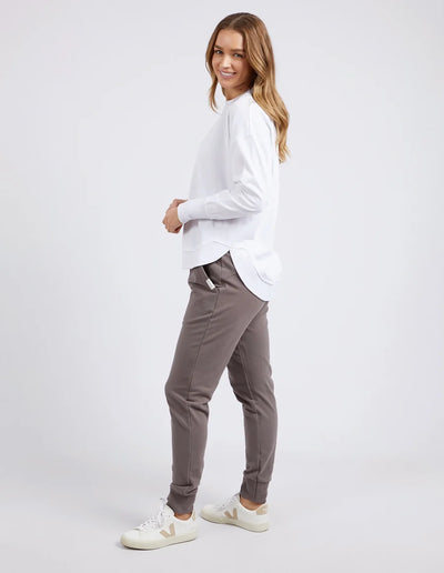 woman wearing foxwood farrah long sleeve in white, khaki pants and vega shoes