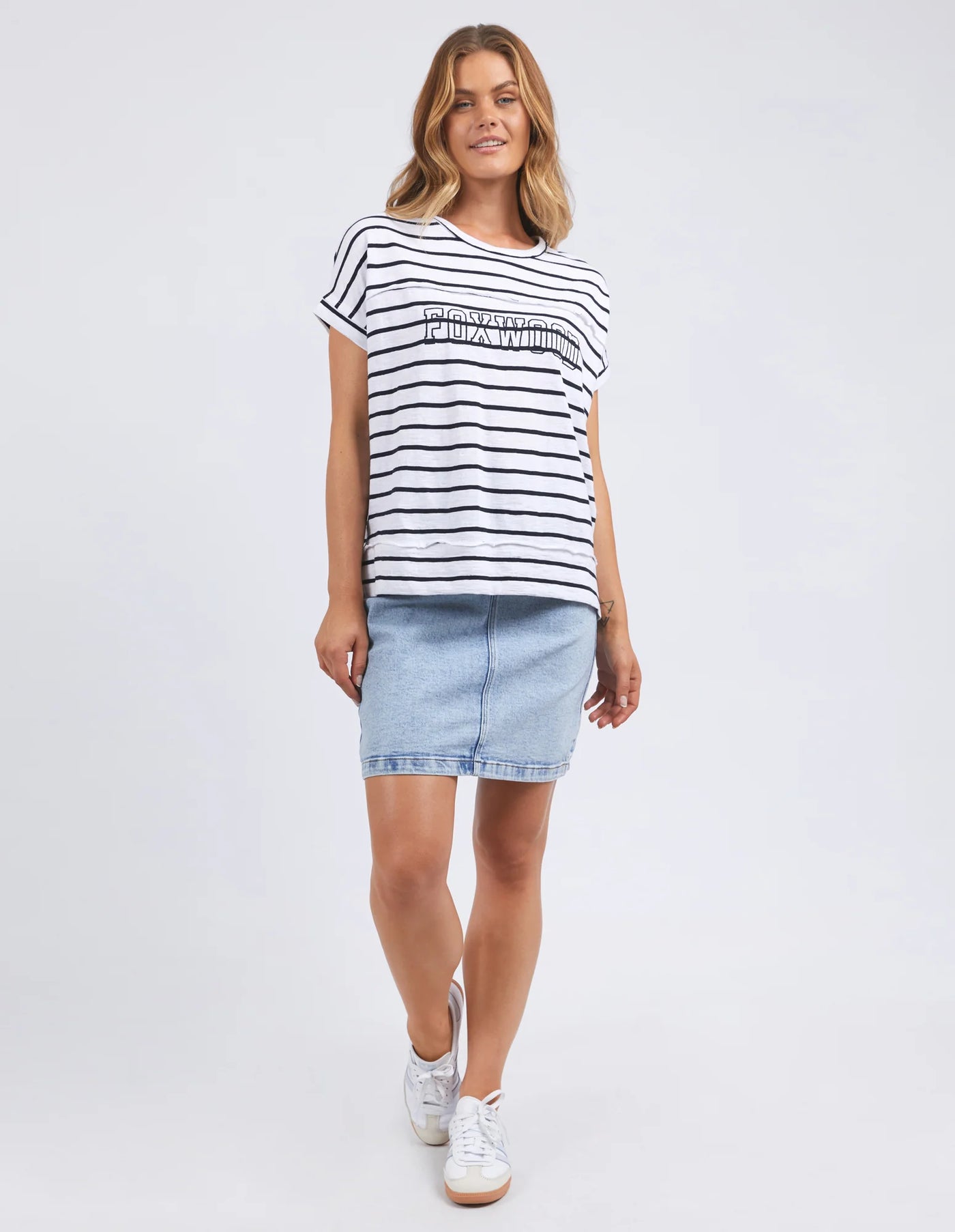 woman wearing throw on tee white navy stripe, denim skirt and samba