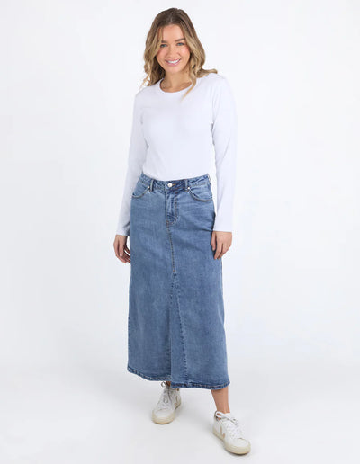 woman wearing white long sleeve top and classic wash parsons denim midi comfort skirt