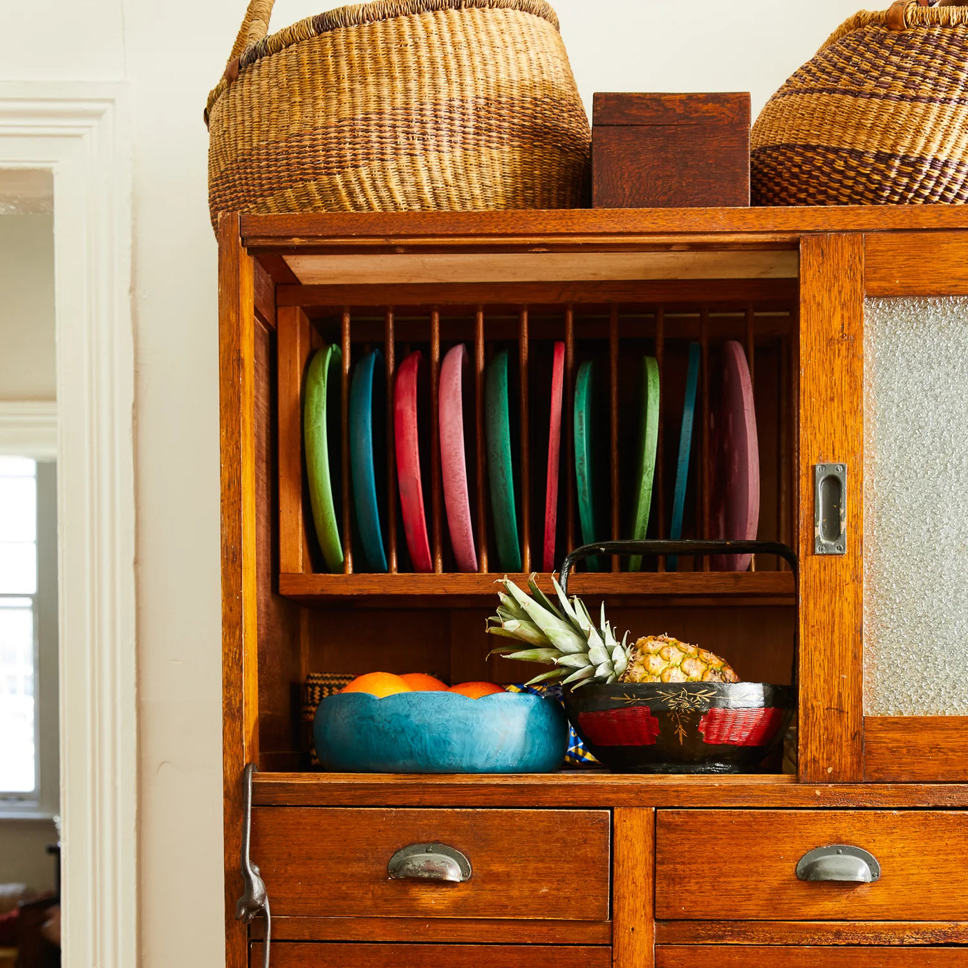 cabinet with plates in different colours and board