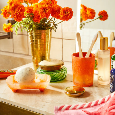 circular soap in the sage and clare daja soap dish persimmon placed in the table