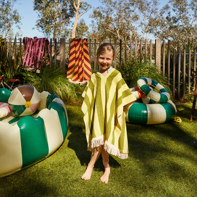 kid wearing sage and clare jarita hooded towel in palm colour